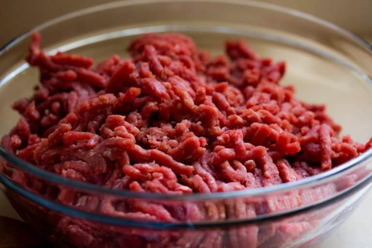 A glass bowl of ground beef